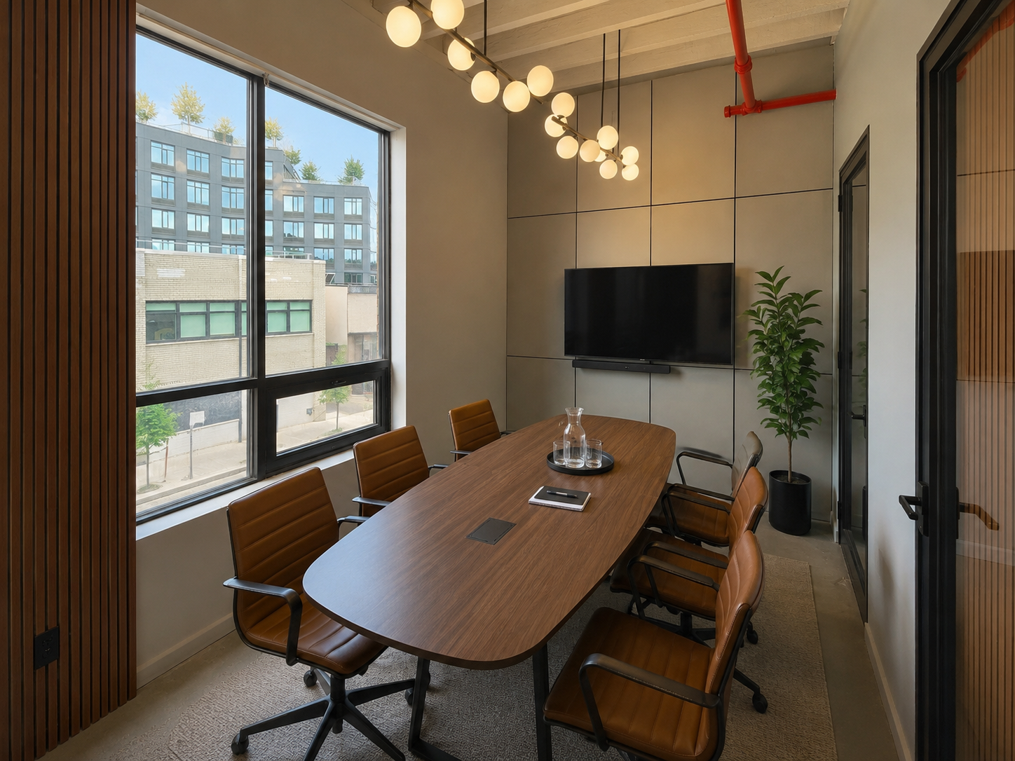 Casa38 meeting room with a large table and presentation screen